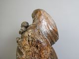 a wooden statue of a woman holding a baby