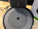 a close up of a robot vacuum on a table next to a box
