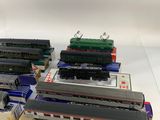 four model trains are sitting on display in boxes on a table