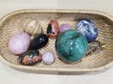 a basket filled with different types of stones on a table