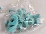 a plastic bag with some blue and green doughnuts in it