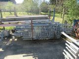 a pile of metal pipes sitting in the middle of a yard