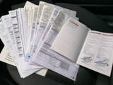 a pile of papers sitting on top of a car seat