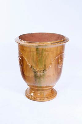 a wooden vase that is sitting on a white surface