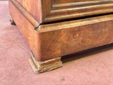 a close up of a wooden dresser with a clock on top of it