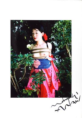 a picture of a woman holding a flower in her hand