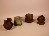 several pieces of pottery sitting on top of a table next to each other