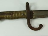 a very old knife that is on display on the table