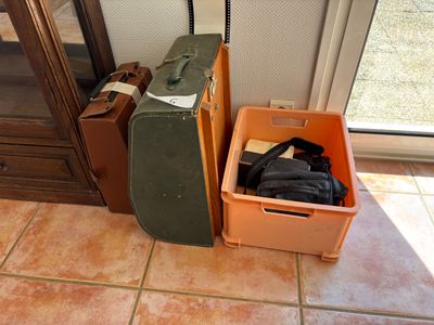 une valise et un étui à valise posés l'un à côté de l'autre sur le sol