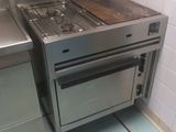 a stove and oven in a small kitchen with tile flooring