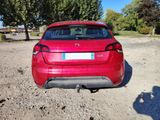 the rear end of a red car parked in a parking lot