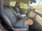 a picture of the interior of a car with black leather seats