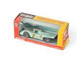 a box with a toy car in it on a white surface