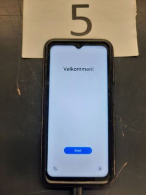 an iphone that is sitting on top of a table next to a sign