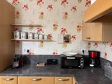 a small kitchen with a microwave, toaster, and toaster on the counter