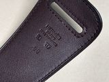 leather case for a cell phone on a table with a white background