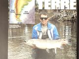 a man holding a large fish in a body of water