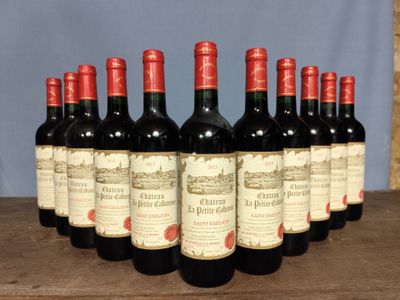 six bottles of red wine lined up in a row on a wooden table