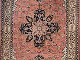 an antique persian rug with a medallion design on a pink ground