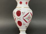 a white vase with a red and yellow design on it