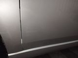 a close up of the side of a silver car