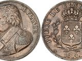 a silver coin with a crown on top of it