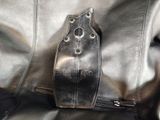 a black leather bag with a zipper on it