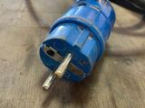a blue plug that is plugged into a wooden table