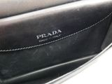 the inside of a black purse with a hand holding it