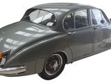 a silver car that is parked on the side of the road