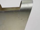 a metal object that is sitting on a white surface