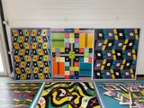 four pieces of art on the floor in a room