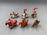 several figurines of knights on horseback with flags and flags