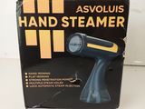 an image of a black and yellow hand steamer sitting on a table