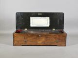 a small wooden box with a computer on top of it