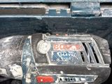a drill that is sitting in the back of a truck