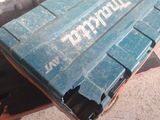 a blue crate sitting on the floor next to a chair