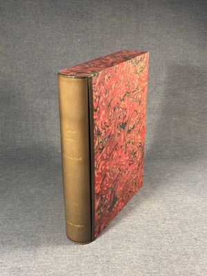 an old book sitting on top of a table next to a gray surface