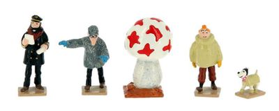 four figurines of people and a dog on a white background