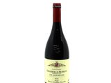a bottle of red wine sitting on top of a white table