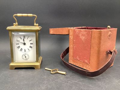 a small clock that is next to a small purse