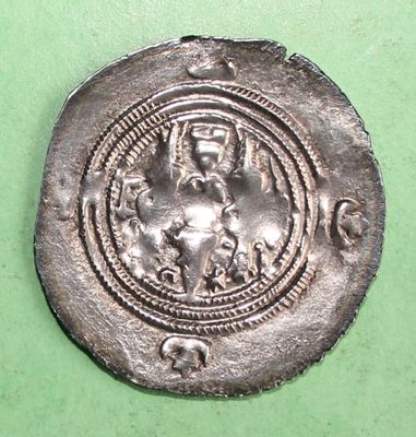 a silver coin with an image of a woman holding a child