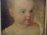 painting of a baby in a white dress in a wooden frame