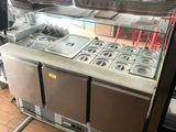 an image of a kitchen with a counter and a refrigerator