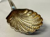 a silver spoon that is sitting on a table