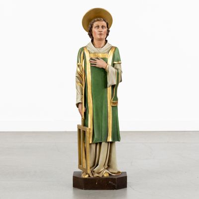 a statue of a man in a green robe and hat