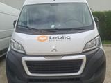 a white van parked in front of a white van