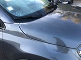 a car parked on the side of the road near a parking meter