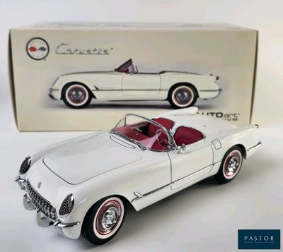 a white toy car with a red top in front of a box