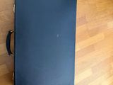 a black box on the floor next to a wooden floor